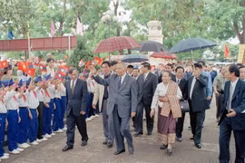 Дети из общины Кимльен, уезда Намдан, провинции Нгеан – малой родины президента Хо Ши Мина – приветствуют президента Кхамтая Сипхандона во время его визита в этот уезд в 2002 году. (Фото: ВИА)