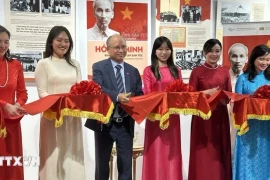 Посол Вьетнама во Франции Динь Тоан Тханг (третий слева) и другие делегаты перерезают ленточку для открытия выставки. (Фото: ВИA)
