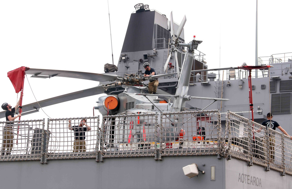 Моряки судна HMNZS Aotearoa проводят техническое обслуживание вертолёта сразу после прибытия в порт города Хошимин. (Фото: ВИА)