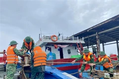 Пограничники помогают рыбакам укрепить и закрепить лодки (Фото: ВИА)