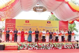 Представители двух стран перерезают ленточку на церемонии открытия проекта по реставрации и обновлению Мемориального комплекса Президента Хо Ши Мина в провинции Саваннехет. (Фото: ВИА)