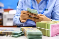Общий объем кредитов экономики достиг более 15,6 квадриллиона донгов (610,3 миллиарда долларов США) в 2024 году (Фото: ВИA)