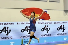 Борец Нгуен Тхи Ми Чанг празднует свою победу. (Фото: tdtt.gov.vn) 