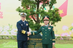 Министр обороны Вьетнама генерал Фан Ван Жанг (справа) и его китайский коллега генерал-полковник Дун Цзюнь сажают памятное дерево на международном пограничном пункте пропуска Монгкай. (Фото: ВИА)