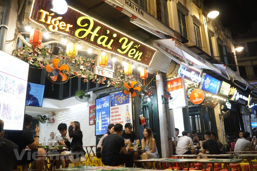  Лето в Ханое очень жаркое, поэтому люди выбирают прохладное пиво в качестве любимого напитка, и чем жарче погода, тем больше людей на улице Тахиен. Каждый вечер зарубежные путешественники и местные жители собираются в укромном уголке, чтобы насладится чашкой холодного пива с закусками или поболтать с друзьями после тяжелого рабочего дня. Другие иностранные туристы посещают этот уголок города, чтобы понаблюдать за повседневной жизнью, а также за очаровательной суетой Ханоя. В отличие от Старого квартала, ночью улица Тахиен более шумная. Более того, громкий веселый смех с сердечными рукопожатиями достаточно хорош, чтобы стать частью культурной красоты “международного перекрестка”. А еще лучше, если туристы согласятся, то труппа местных уличных артистов всегда готова к выступлению. (Фото: Vietnam+)