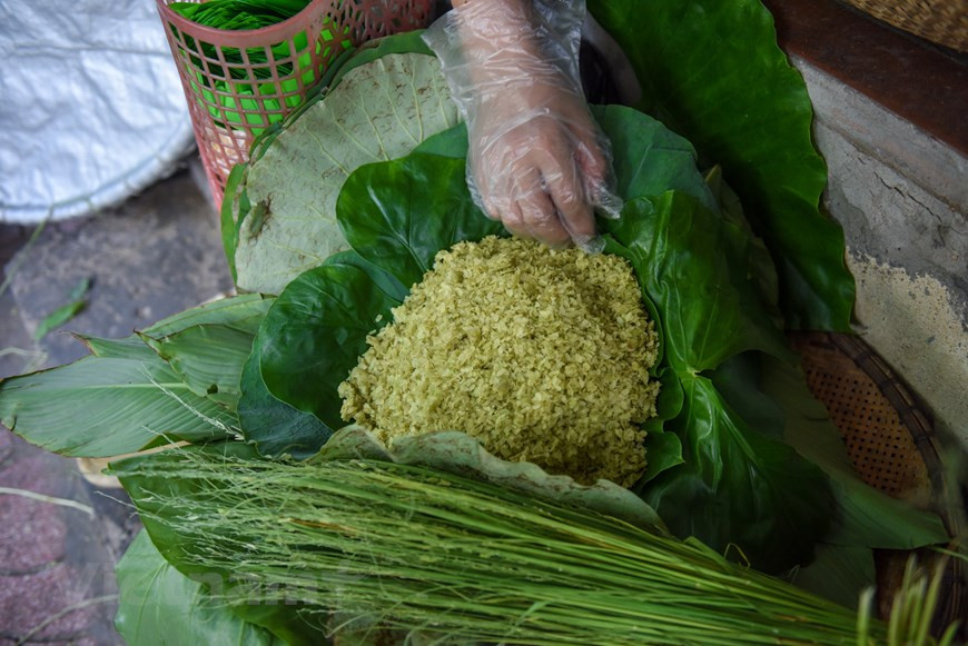 Ком уже много лет является незаменимым блюдом вьетнамской кулинарной культуры каждую осень. Молодой клейкий рис «ком» появился в Ханое уже давным-давно. Выбор вида клейкого риса для приготовления кома является очень важным шагом, потому что от этого зависит вкус и аромат кома. Обычно 10 кг риса дает 1,6-1,7 кг «ком». Рис нужно собирать в 90-ые дни после посева, тогда «Ком» будет мягкими и сладкими Зеленый ком часто заворачивают в листья лотоса, потому что этот тип листьев помогает сохранить запах кома. «Сой ком» - особенное блюдо, потому что его можно приготовить только осенью, во время сезона зелёного клейкого риса. Вот почему он стал традиционным осенним ханойским блюдом. (Фото: Vietnam+)