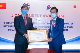 Президент JICA г-н Китаока Шиничи (слева) вручил Почетную грамоту директору Национального института гигиены и эпидемиологии. (Фото: корр./ Vietnam +)
