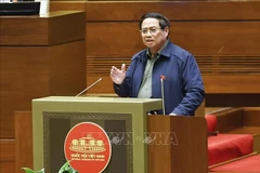 Премьер-министр Фам Минь Тьинь выступает с пояснениями, разъясняя ряд вопросов, поднятых депутатами Национального собрания. (Фото: ВИА)