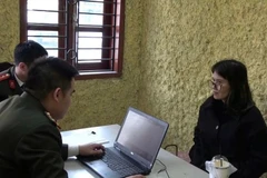 Хоанг Тхи Хонг Тхай в подразделении полиции. Фото: Полиция города Ханоя. (Фото: ВИА)