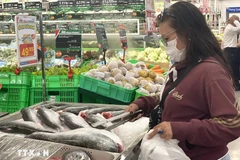 Потребители выбирают рыбные продукты в супермаркете. (Фото: ВИА)