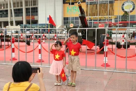 Жители и туристы с энтузиазмом фотографируются с церемониальными пушками