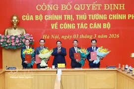 Фам Минь Тьинь, секретарь партийного комитета Правительства, Премьер-министр, вручает Решения Политбюро и Премьер-министра о кадровой работе. (Фото: ВИА)