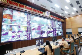 Кадры и бойцы дорожной полиции осуществляют круглосуточный мониторинг дорожного движения с помощью ИИ-камер в Информационно-командном центре Департамента дорожной полиции Министерства общественной безопасности Вьетнама. (Фото: ВИА)