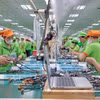 Сборочная линия продукции после обработки на заводе компании Bandai Vietnam. (Фото: ВИА)